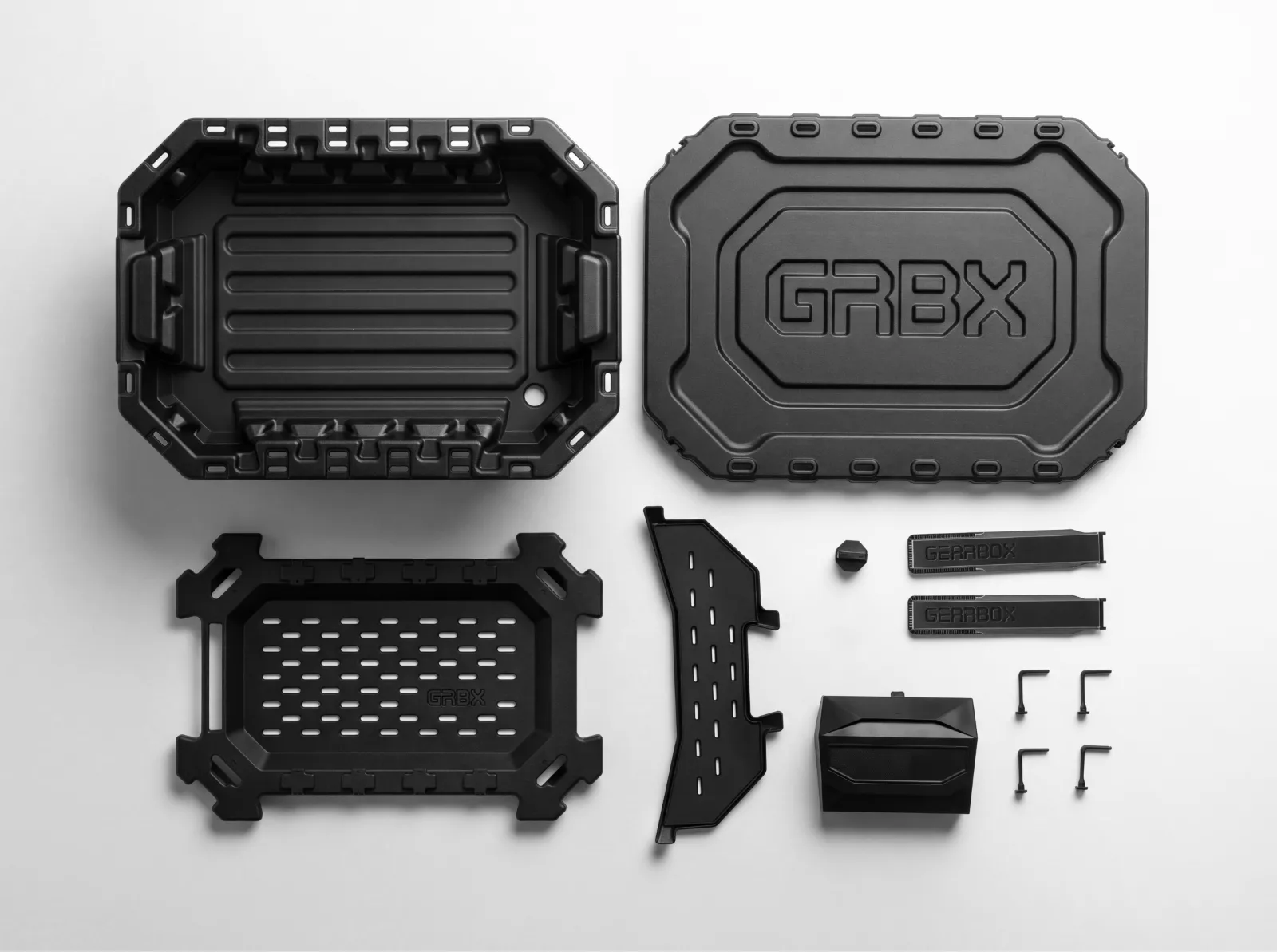 Base Kit flatlay — bin, lid, airflow sub-floor, top tray, two drying accessories, four lid tethers, drain plug and fan, laid out on white