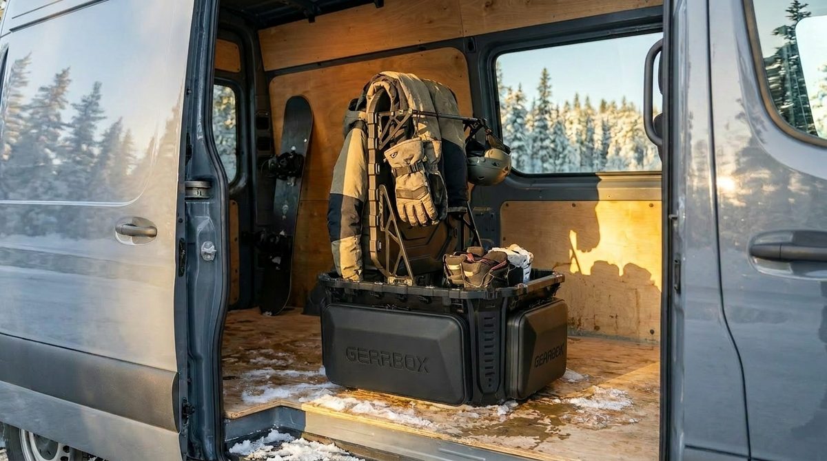 GRBX bin in a van with snowboard gear and jacket drying, snowy forest outside